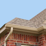 House roof, gutters and downspout on the corner of a house.